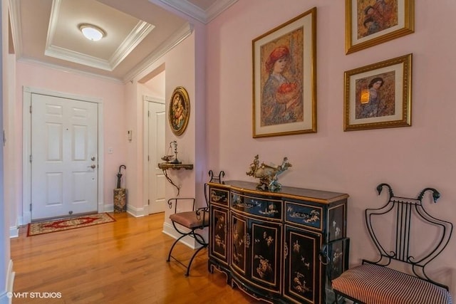 foyer entrance with wood-type flooring and ornamental molding