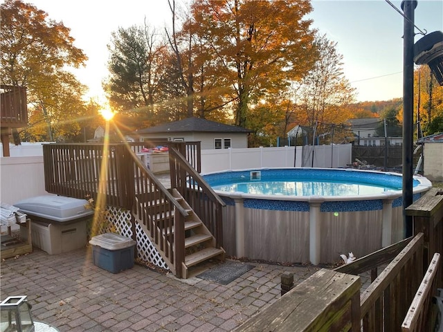 pool at dusk with a deck