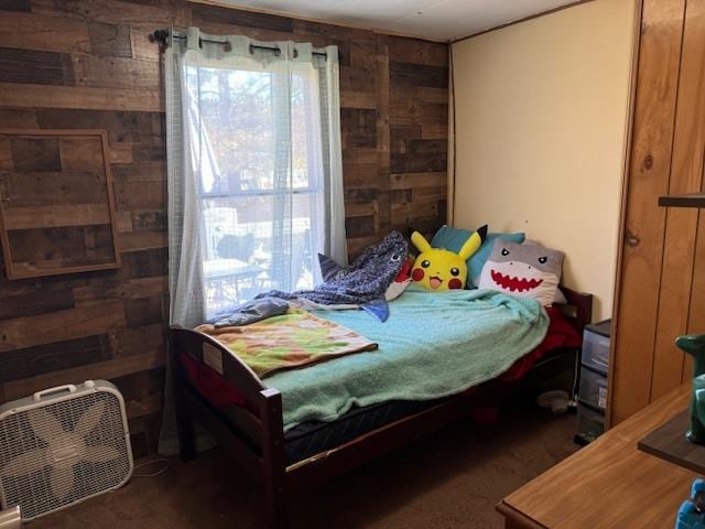 bedroom featuring wooden walls