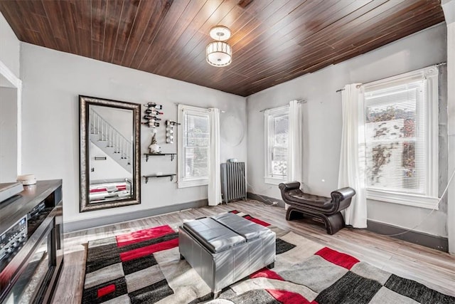 sitting room featuring wooden ceiling, radiator heating unit, and light hardwood / wood-style flooring