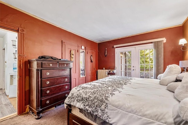 bedroom featuring french doors, access to outside, ornamental molding, and wood-type flooring