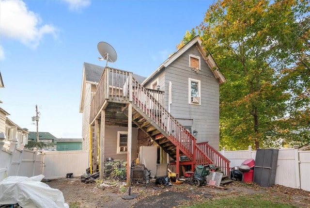 rear view of house with a wooden deck