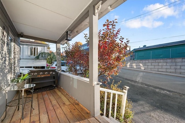 wooden terrace with a porch