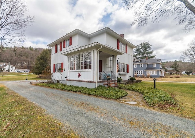 view of side of property with a lawn