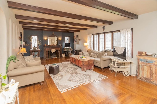 living room with beamed ceiling and hardwood / wood-style floors