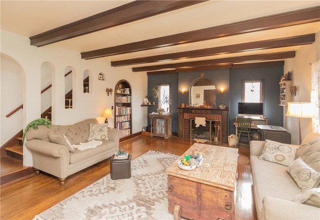 living room with beamed ceiling and hardwood / wood-style flooring