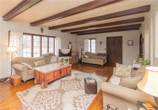 living room with beamed ceiling and hardwood / wood-style flooring