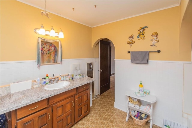 bathroom featuring vanity and ornamental molding