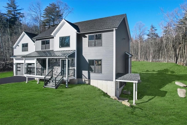 rear view of house featuring a yard and a porch