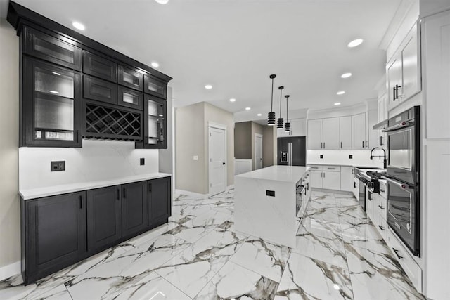 kitchen with black refrigerator with ice dispenser, sink, white cabinets, a kitchen island, and hanging light fixtures