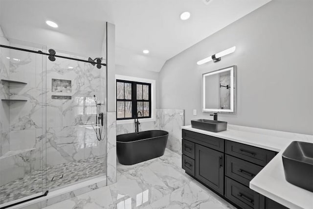 bathroom featuring vanity, lofted ceiling, and independent shower and bath