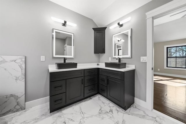 bathroom featuring hardwood / wood-style floors, vanity, and vaulted ceiling