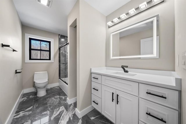 full bathroom featuring vanity, enclosed tub / shower combo, and toilet