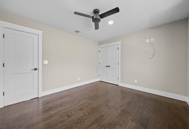 unfurnished room featuring dark hardwood / wood-style floors and ceiling fan