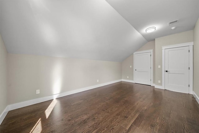 bonus room with dark hardwood / wood-style floors and lofted ceiling