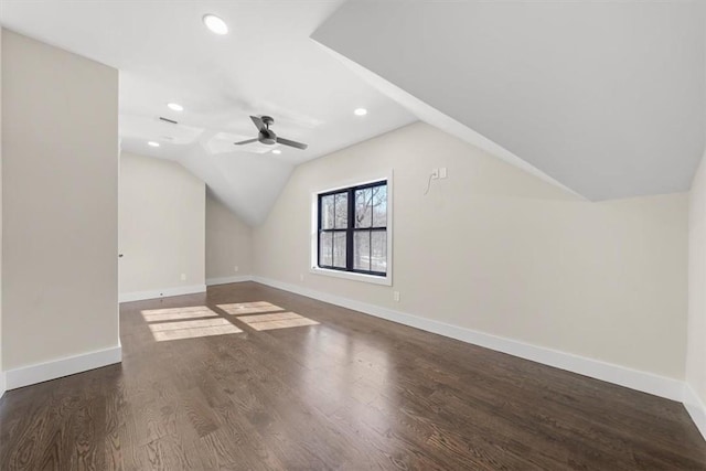 additional living space with dark hardwood / wood-style flooring, vaulted ceiling, and ceiling fan