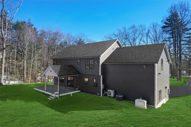 rear view of property featuring a lawn