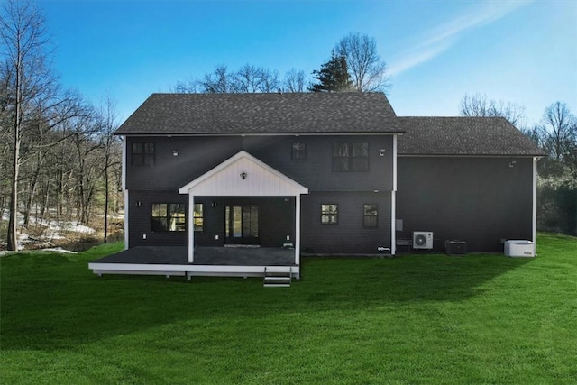 rear view of house with a yard