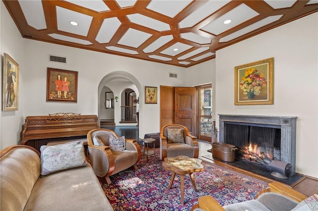 living room with beam ceiling, hardwood / wood-style flooring, crown molding, and coffered ceiling