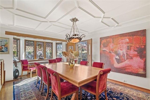 dining space with a wealth of natural light, hardwood / wood-style floors, and a notable chandelier