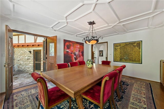 dining area featuring hardwood / wood-style floors and an inviting chandelier