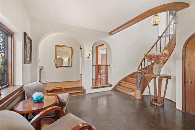 interior space with stairs and arched walkways