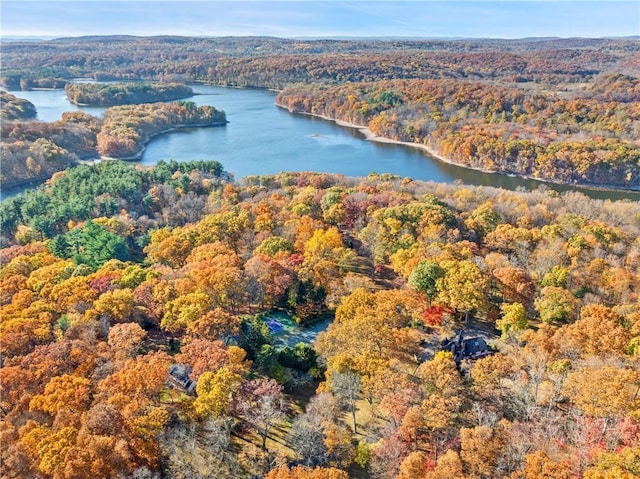 aerial view with a water view and a forest view