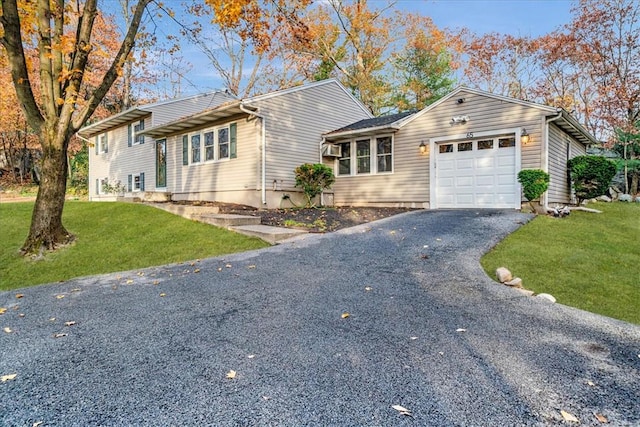 ranch-style house with a front yard and a garage