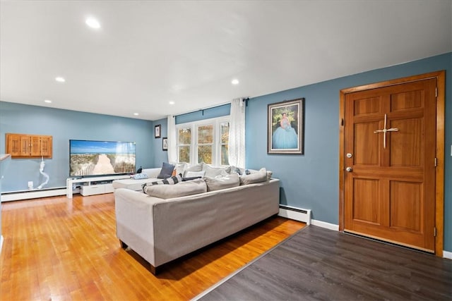 living room featuring wood-type flooring and baseboard heating