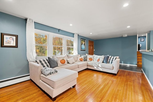 living room with hardwood / wood-style floors and a baseboard radiator