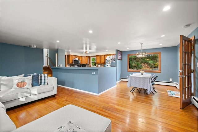 living room with light hardwood / wood-style flooring and baseboard heating