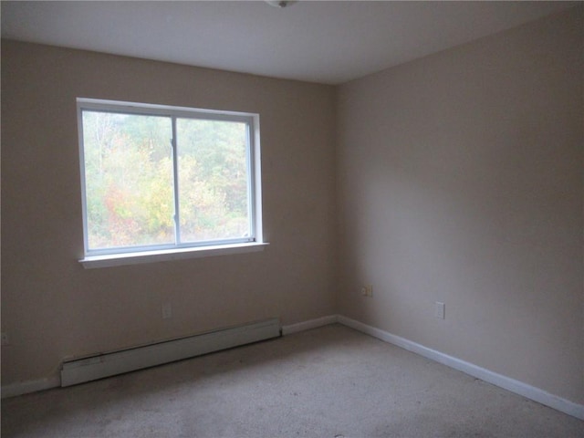 unfurnished room featuring baseboard heating and light colored carpet