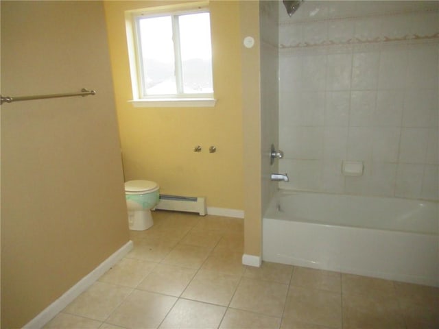 bathroom featuring tile patterned flooring, toilet, tiled shower / bath, and a baseboard heating unit