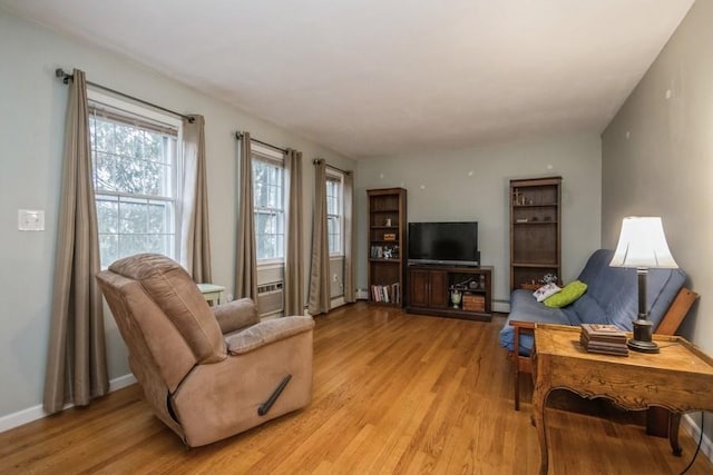 living room with baseboard heating and light wood-type flooring