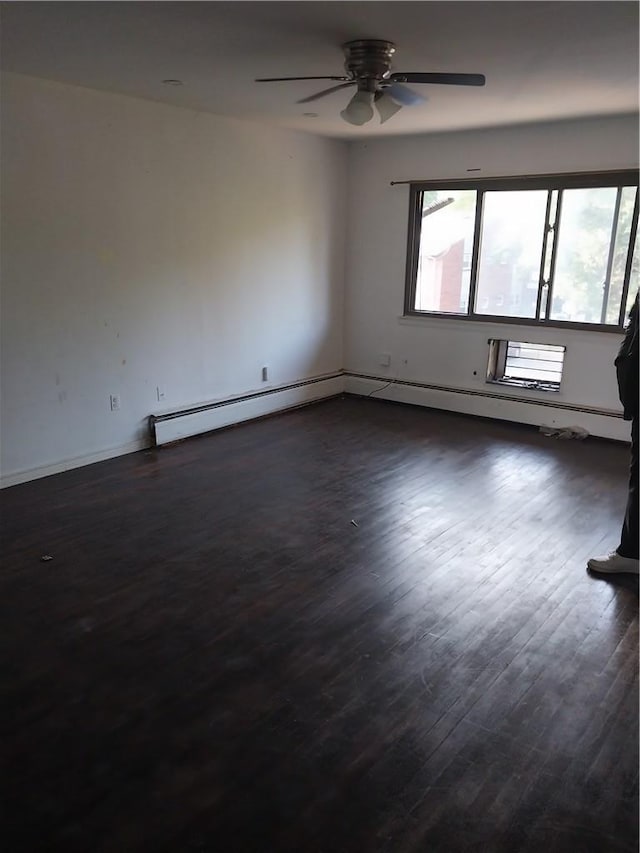 empty room with a baseboard radiator and dark wood-type flooring