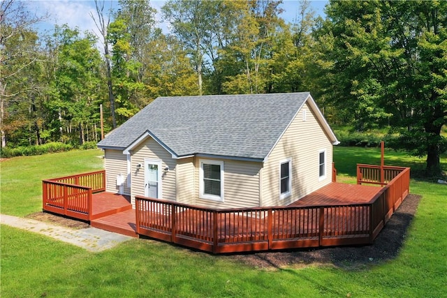 back of house with a lawn and a deck