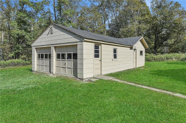 garage featuring a lawn