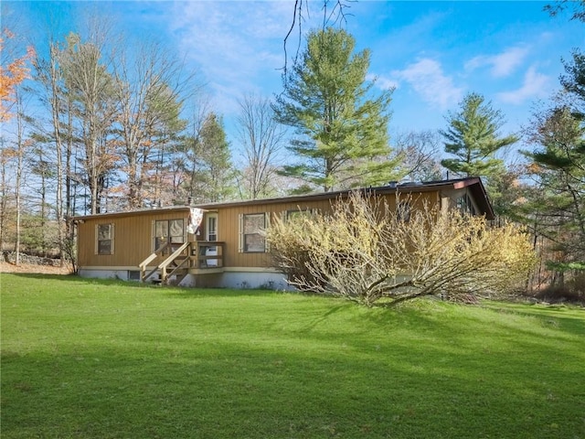 rear view of property featuring a yard