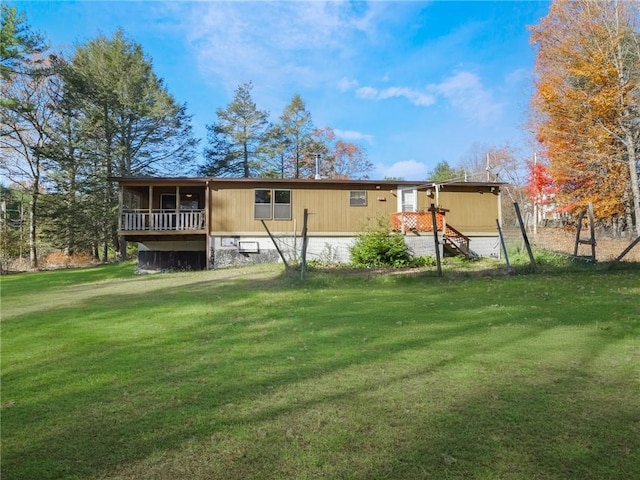 rear view of house featuring a lawn