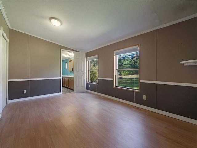 unfurnished room featuring hardwood / wood-style floors and ornamental molding