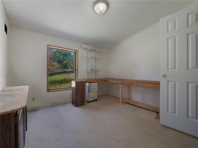 unfurnished office featuring light carpet and built in desk