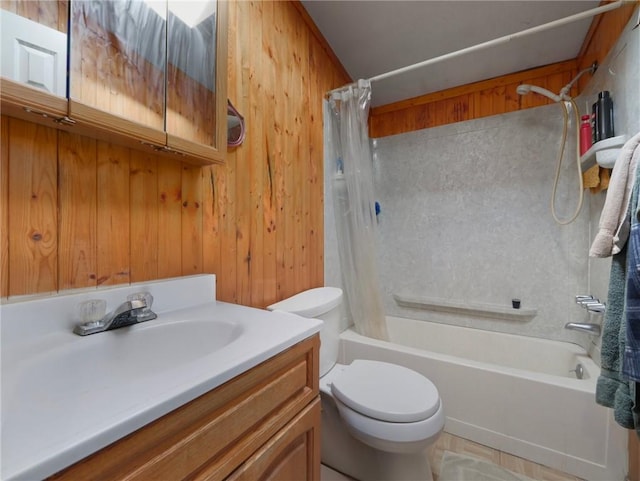 full bathroom with wooden walls, shower / tub combo with curtain, vanity, and toilet