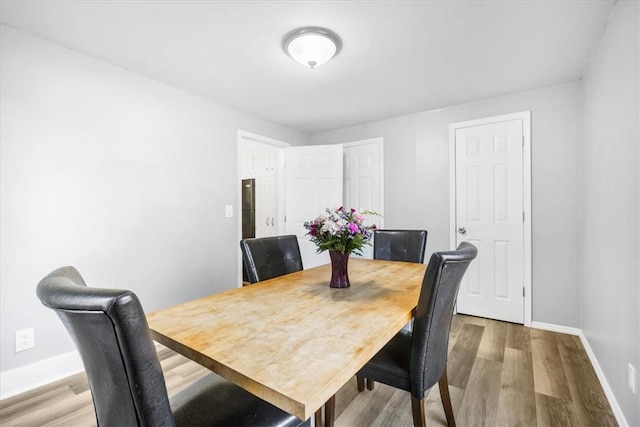 dining space with hardwood / wood-style flooring