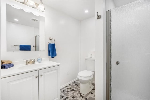 bathroom with tile patterned flooring, vanity, toilet, and a shower