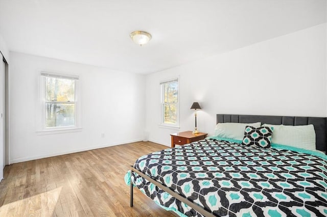 bedroom featuring light wood-type flooring and multiple windows