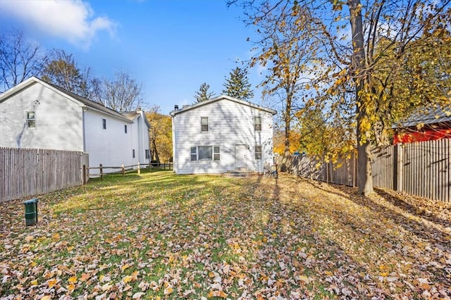 rear view of house featuring a lawn