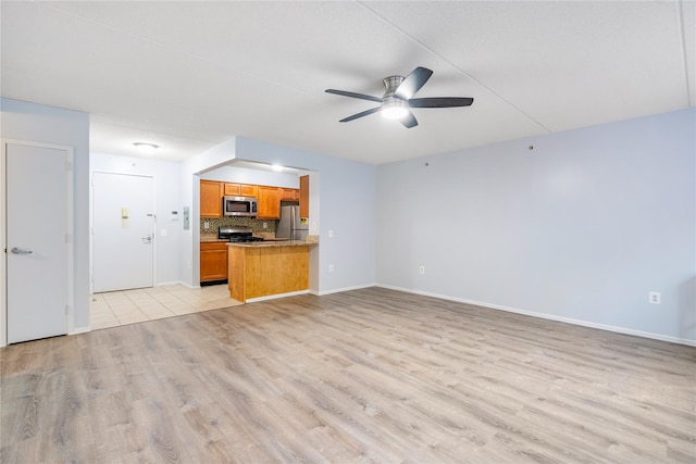 unfurnished living room with ceiling fan and light hardwood / wood-style floors