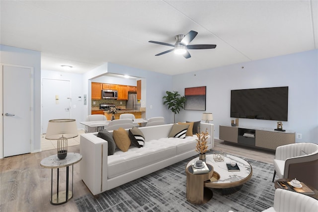 living room featuring ceiling fan and light wood-type flooring