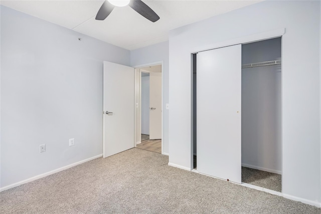 unfurnished bedroom featuring light carpet, a closet, and ceiling fan