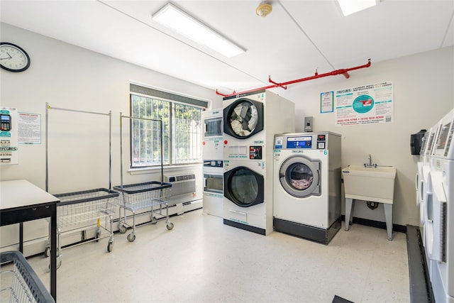 washroom with separate washer and dryer, sink, and stacked washer and clothes dryer